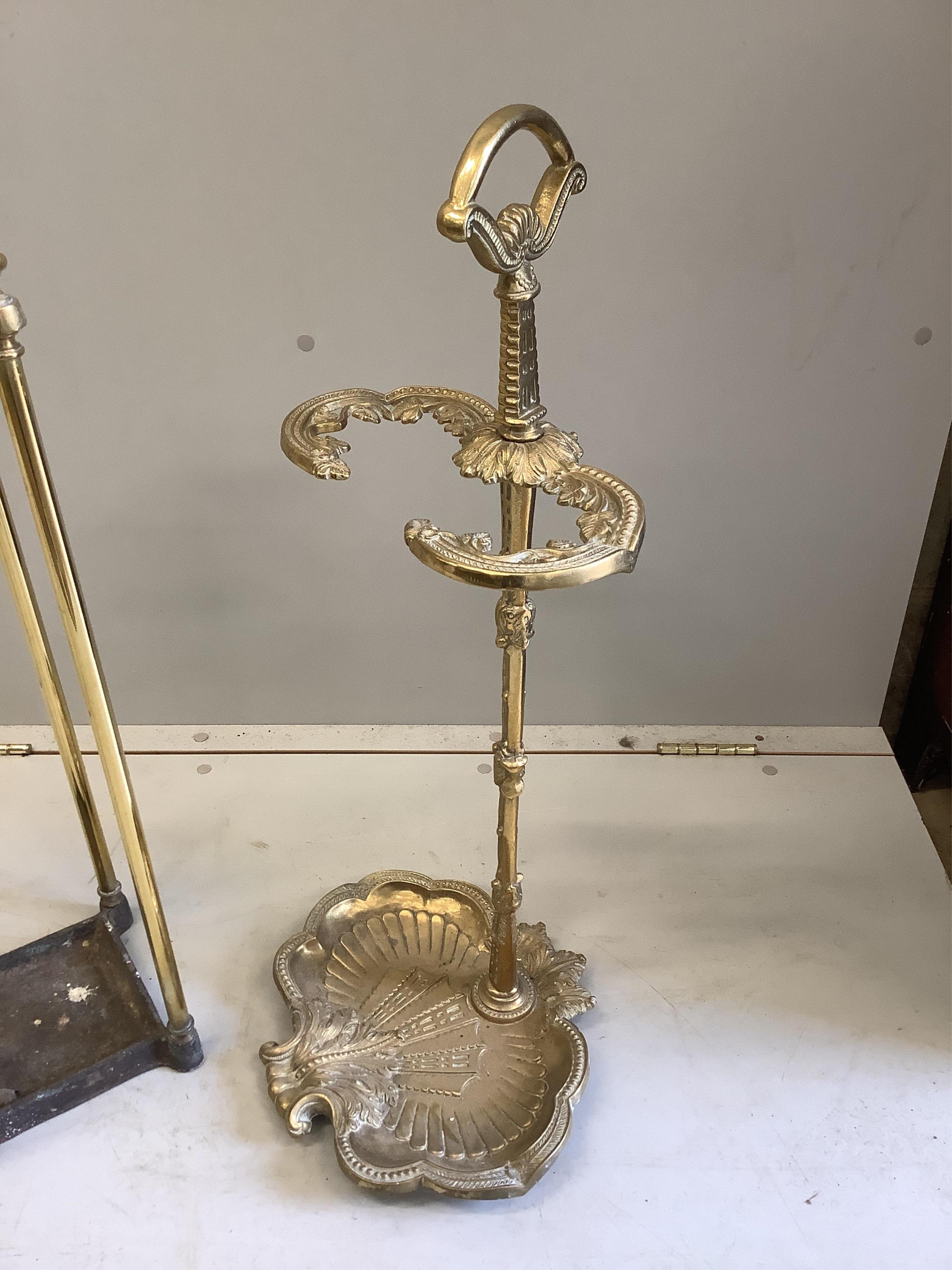 An early 20th century brass and cast iron four division stick stand, height 68cm, together with a reproduction brass stick stand. Condition - good